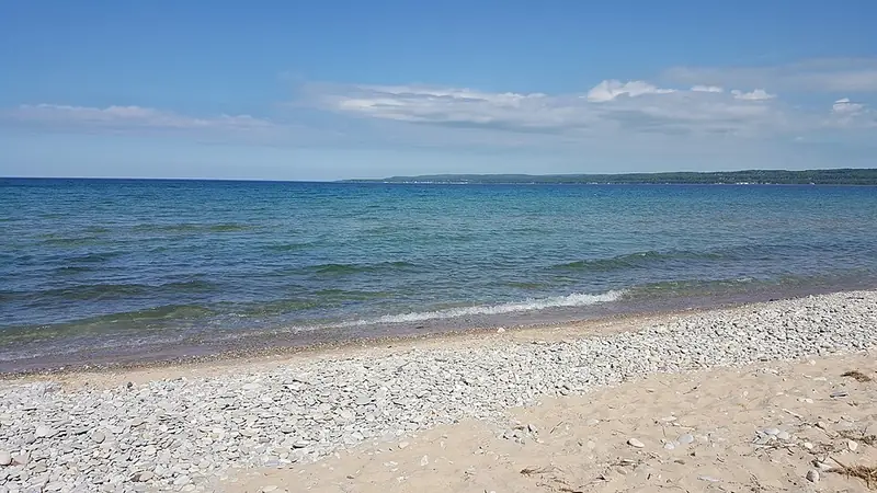 Pebbly Lake Michigan beach with clear blue water