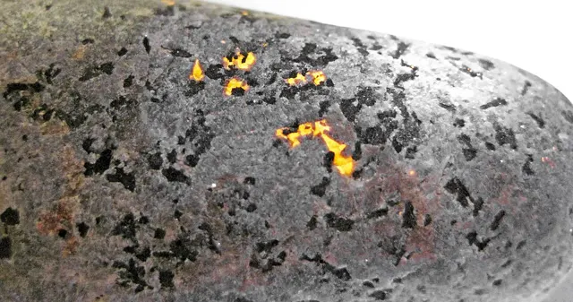 Yooperlite cobble under UV light, Lake Superior shore, Upper Peninsula